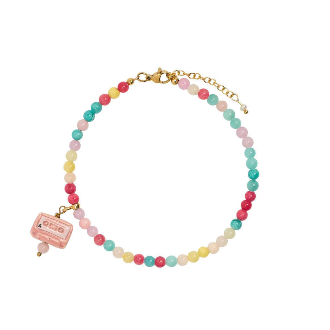 Multicolored beaded bracelet with a small pink lock charm on a white background

