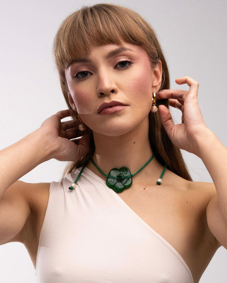 green cord and ceramic flower necklace on model