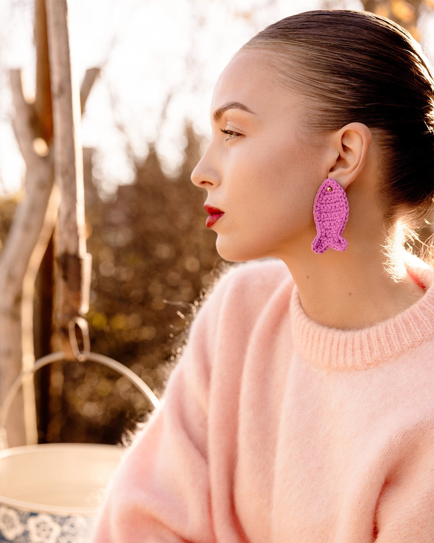 handmade crochet fish appliqué earrings on model