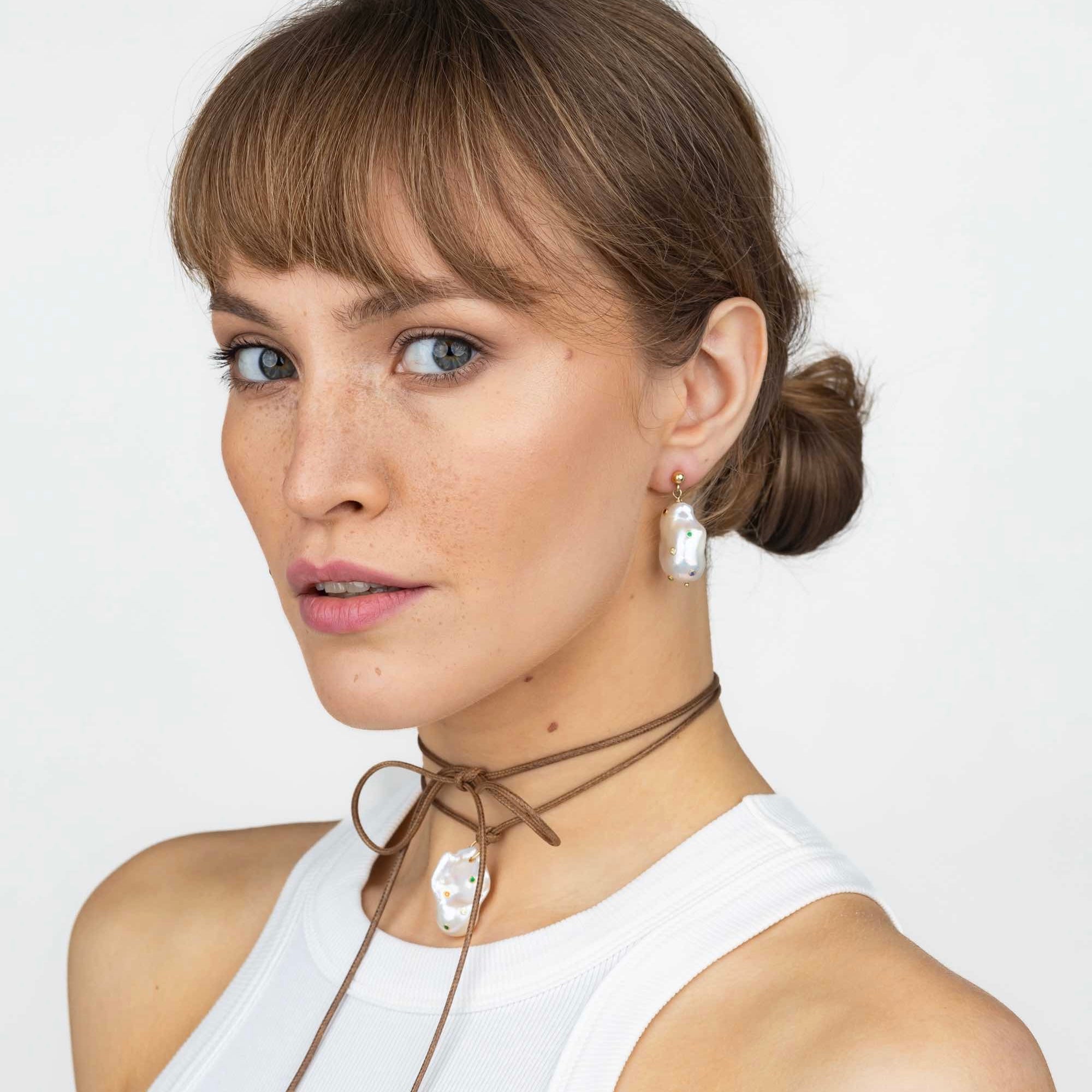 model wearing baroque pearls earrings with CZ stones