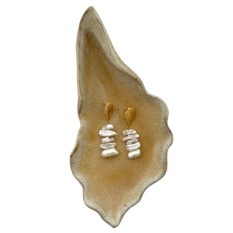 Pearl earrings on a shell cast